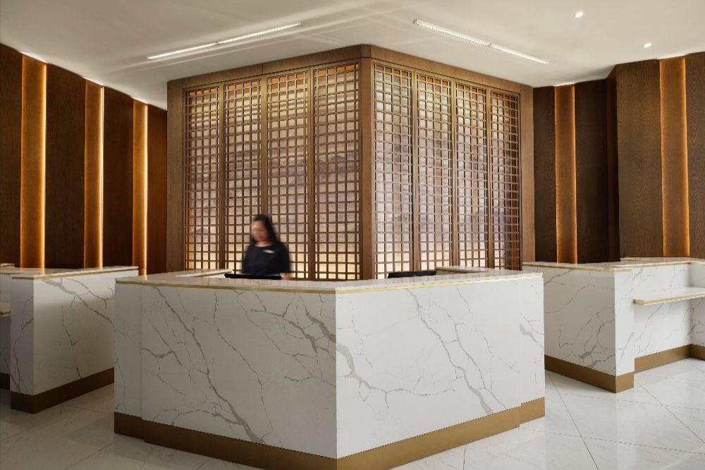 Person standing behind hotel lobby reception desk